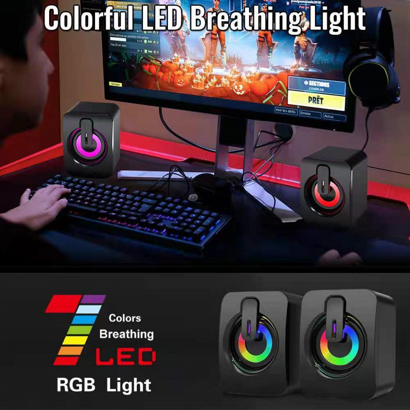 Gaming-Setup mit Lautsprechern mit RGB-Lichtern, Tastatur und Monitor, der eine Spieloberfläche anzeigt.