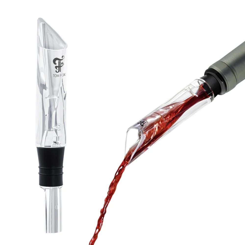 Due aeratori per vino. Uno verticale, trasparente con base nera. L'altro versa vino rosso.