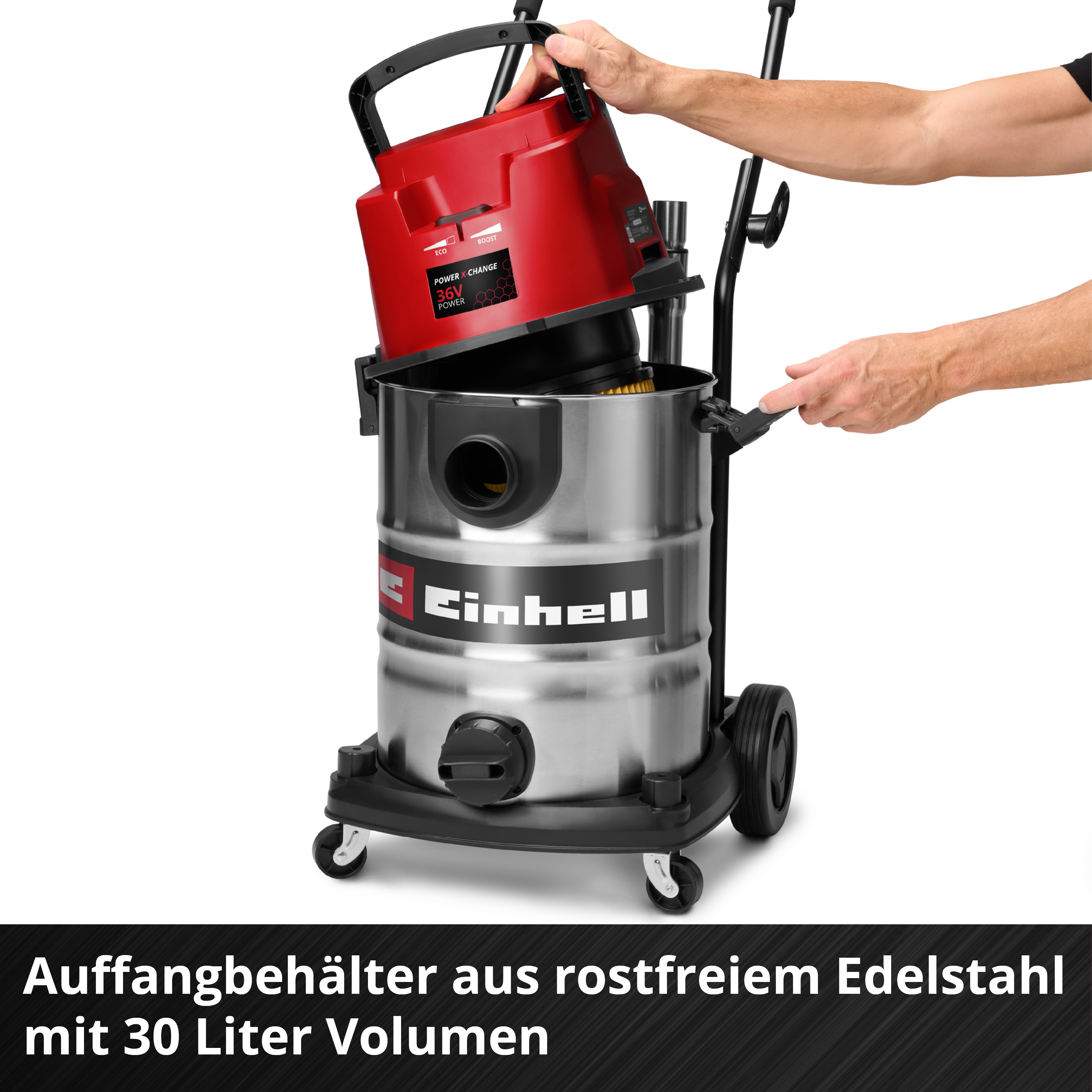 Eine Person, die einen roten und silbernen Staubsauger zusammenbaut. Der Staubsaugerkörper ist aus Stahl, mit schwarzen Rädern.