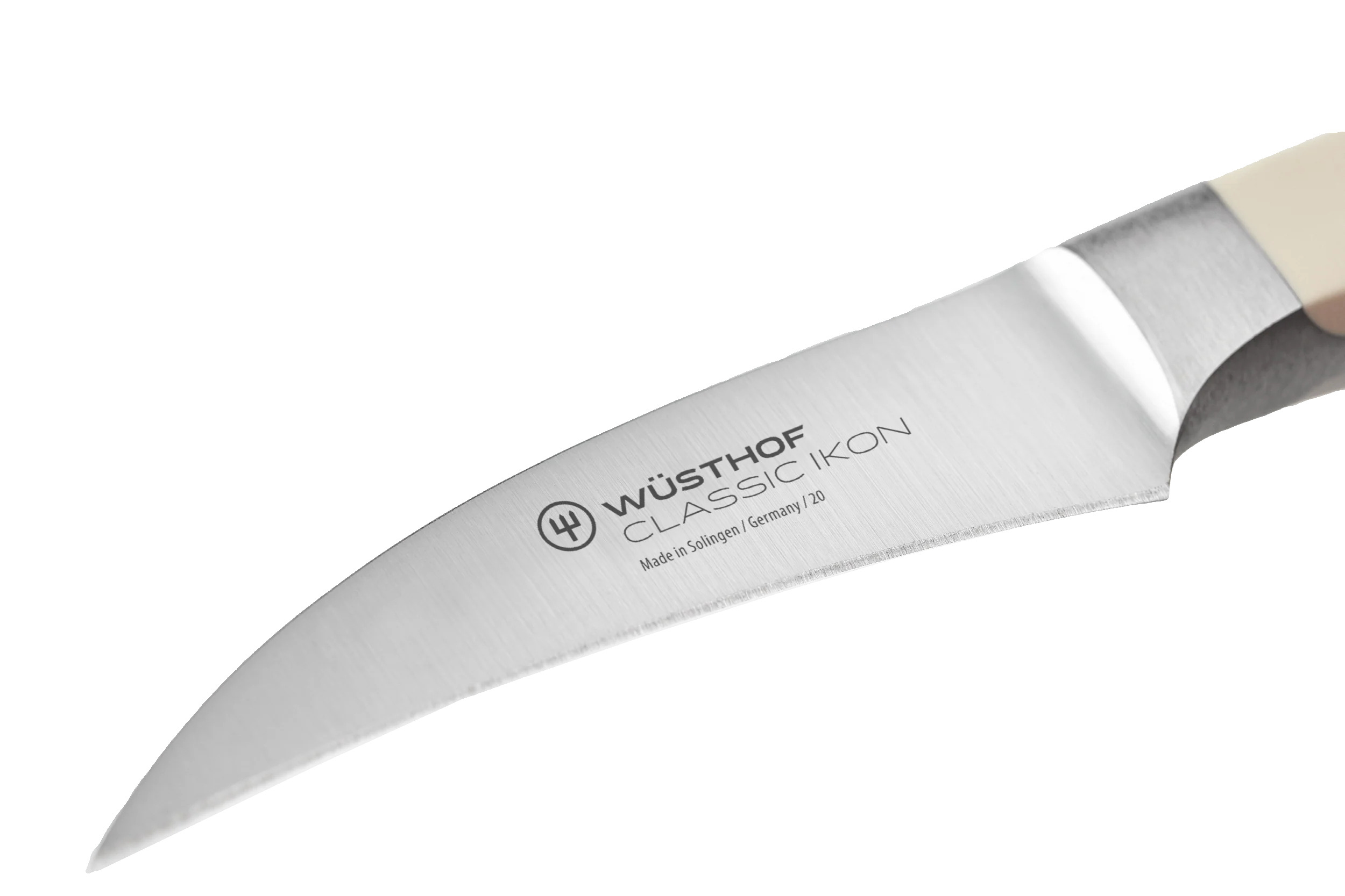 Nahaufnahme eines Wüsthof Classic Ikon Schälmessers. Die Klinge ist silber, der Griff cremefarben.