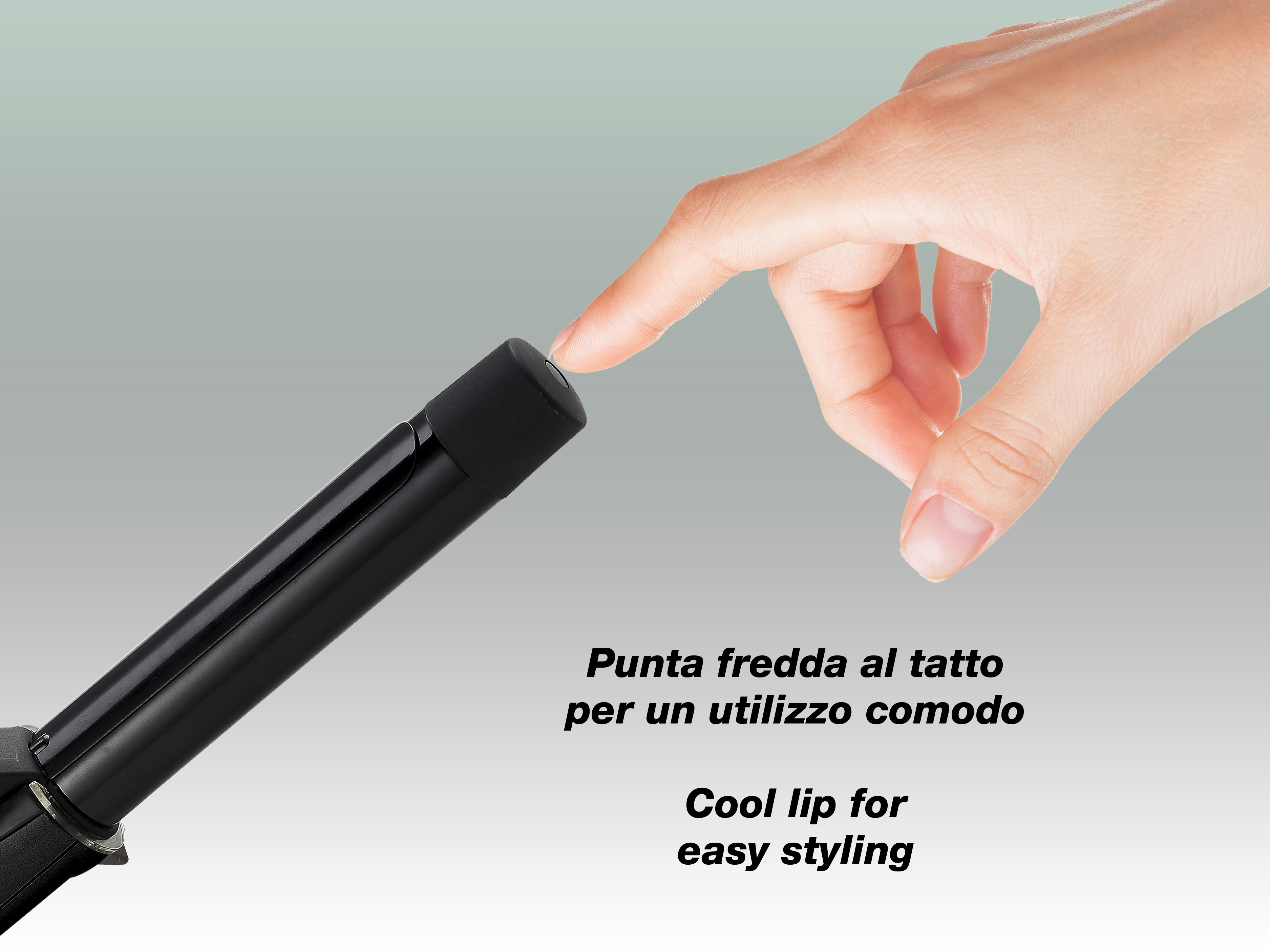 Una mano tocca la punta fredda di un arricciacapelli nero. Lo sfondo è un gradiente grigio e bianco.