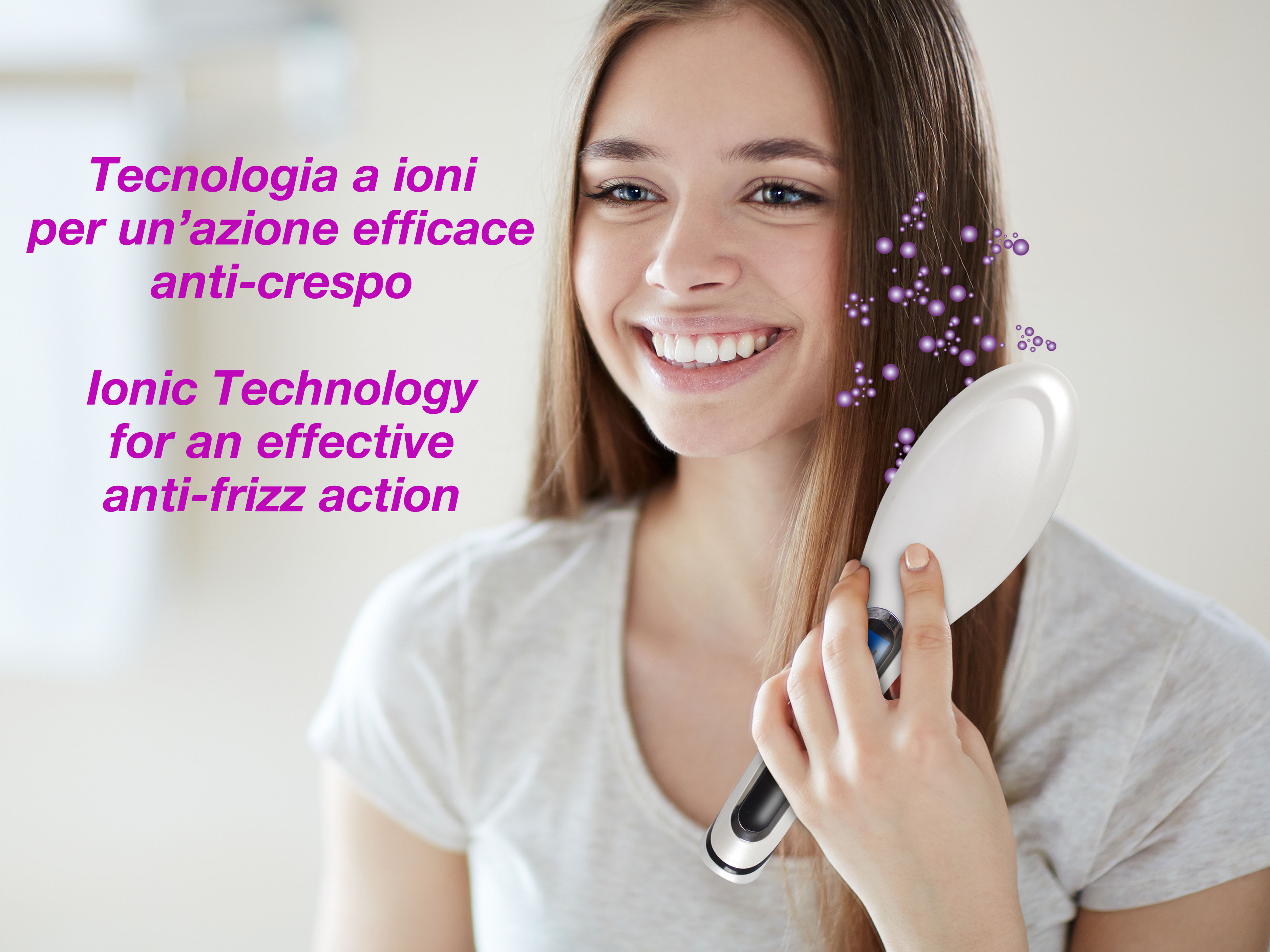 Una donna sorride, tenendo una spazzola bianca per capelli che emette particelle viola. Testo: Tecnologia ionica anti-crespo.