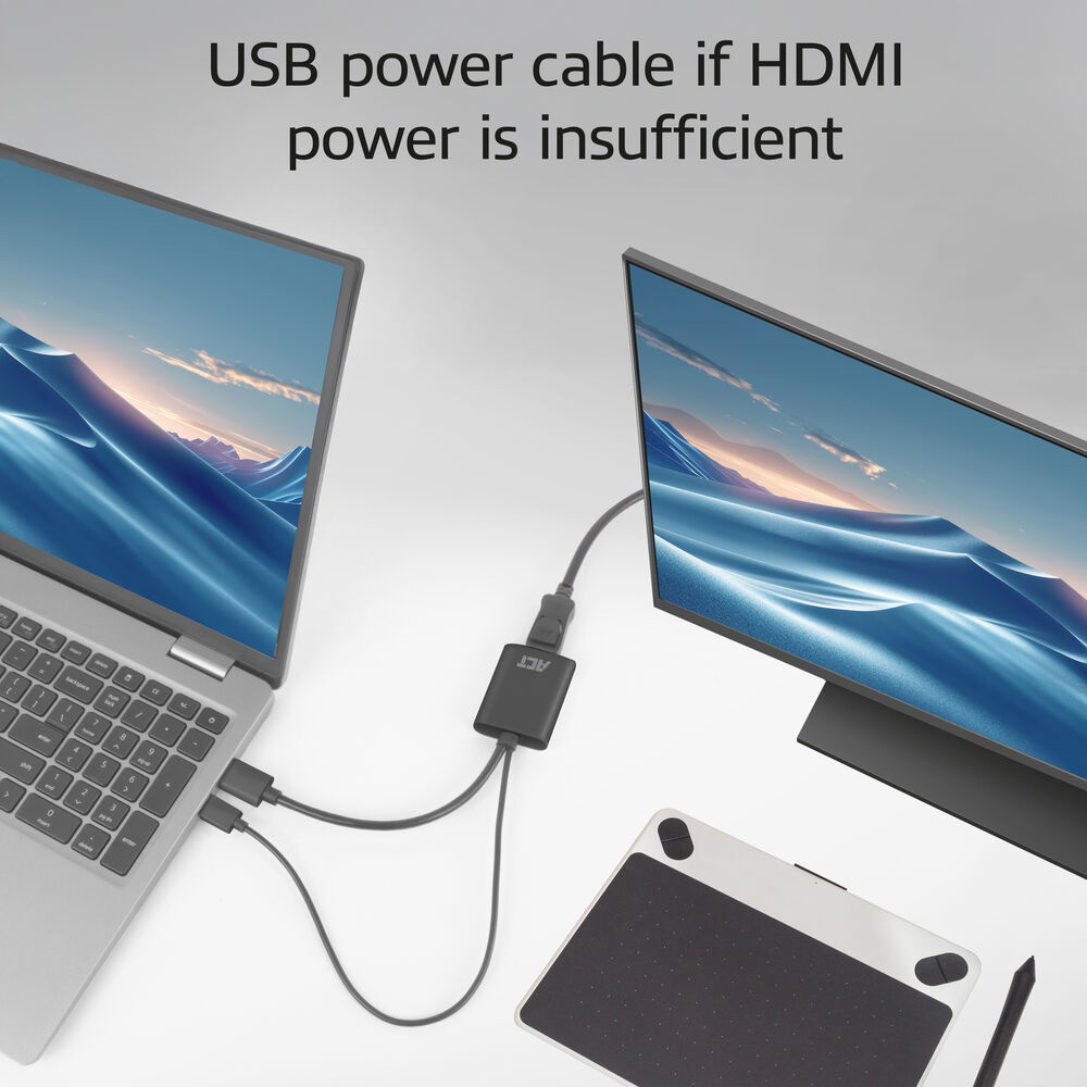 La laptop y el monitor están conectados por HDMI. También se muestra un adaptador negro y un cable USB, y una tableta de dibujo en primer plano.