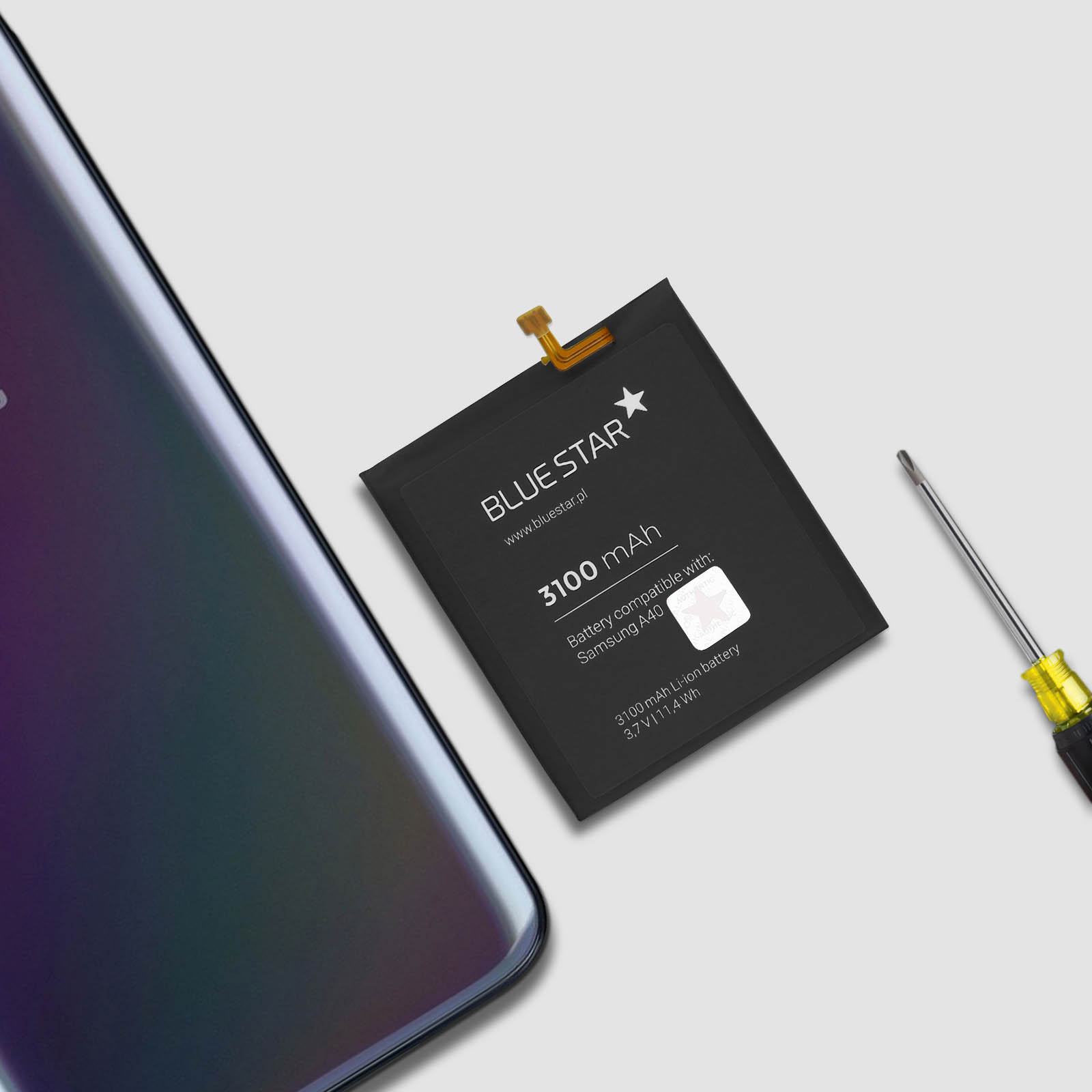 Una batteria del telefono con un cacciavite e uno smartphone. La batteria è nera e presenta il logo Blue Star.