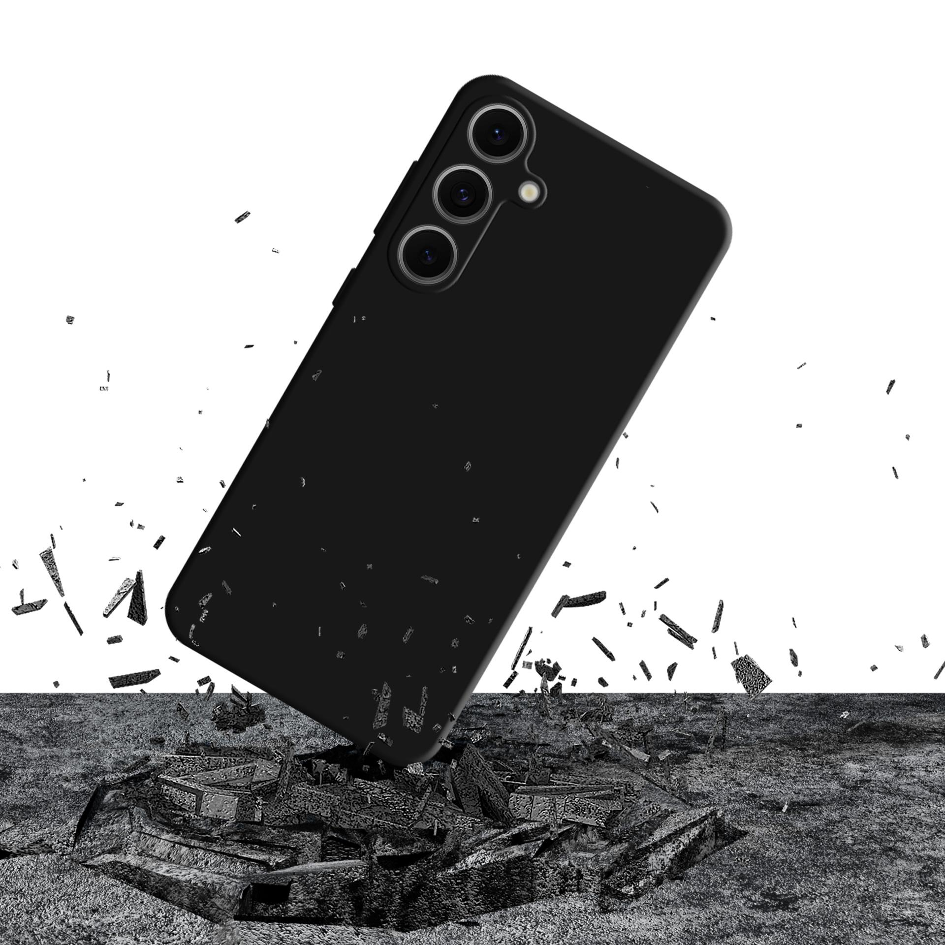 Un telefono nero sfonda una superficie grigia. Detriti sparsi, su sfondo bianco.