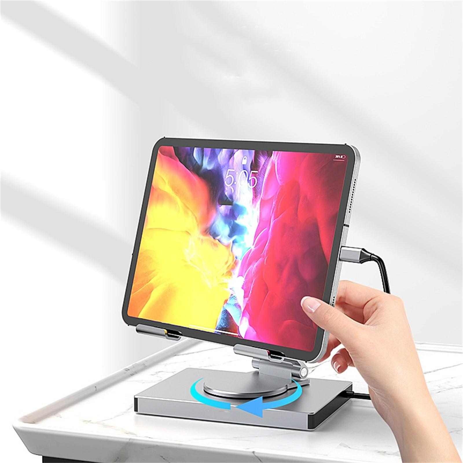 Tablet auf einem Ständer, gehalten von einer Hand. Der Bildschirm zeigt ein farbenfrohes Bild. Der Ständer hat eine Drehbasis.
