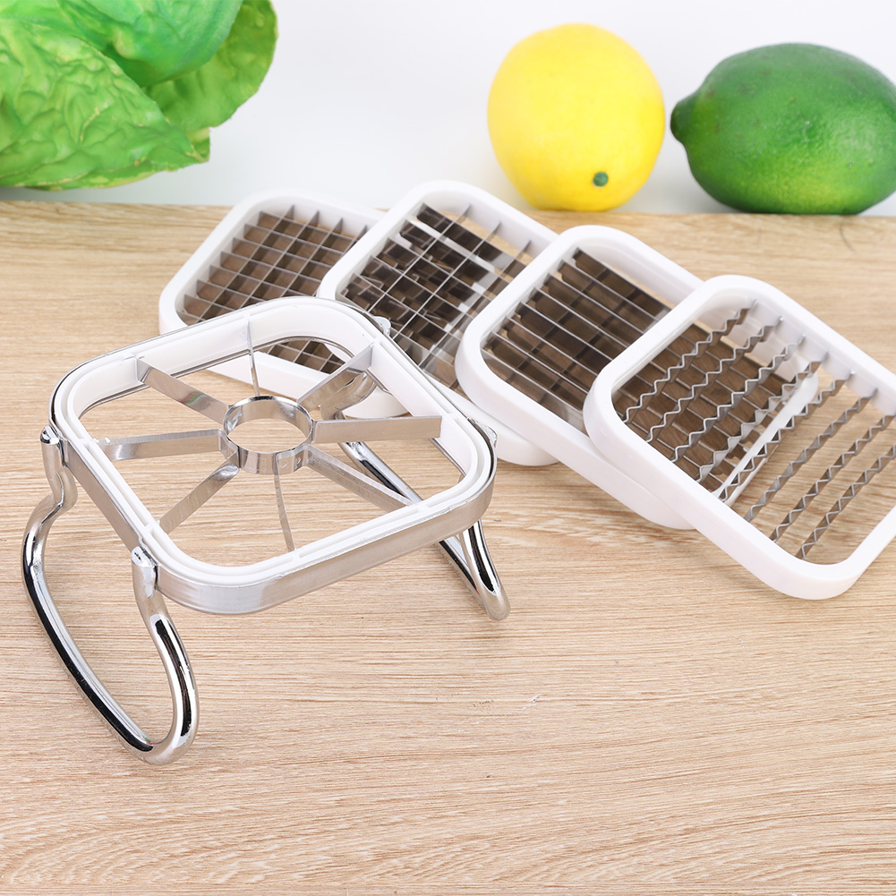 Mehrere weiße und silberne Obstschneider liegen auf einer Holzoberfläche mit einer gelben Zitrone und einer grünen Limette.