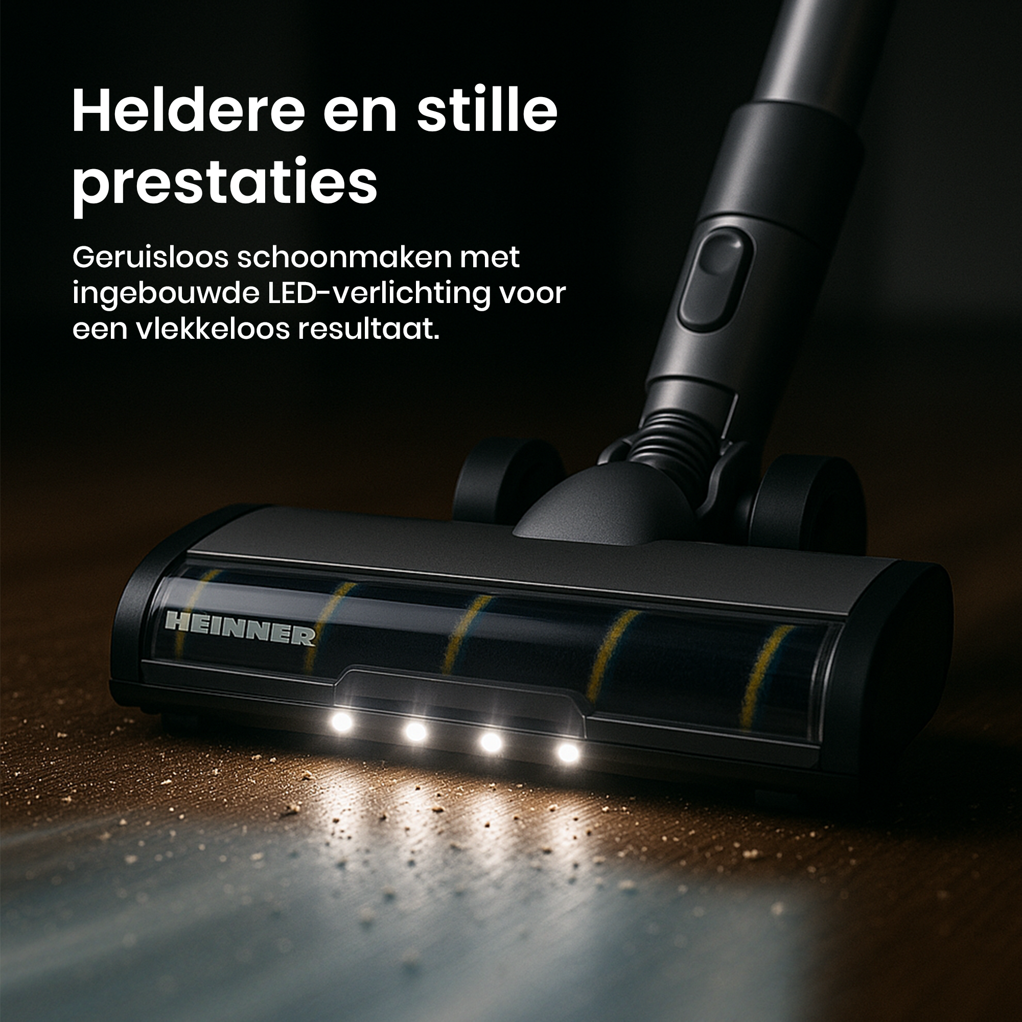 Gros plan d'une tête d'aspirateur avec des lumières LED. La marque est Heinner. La surface est couverte de poussière.
