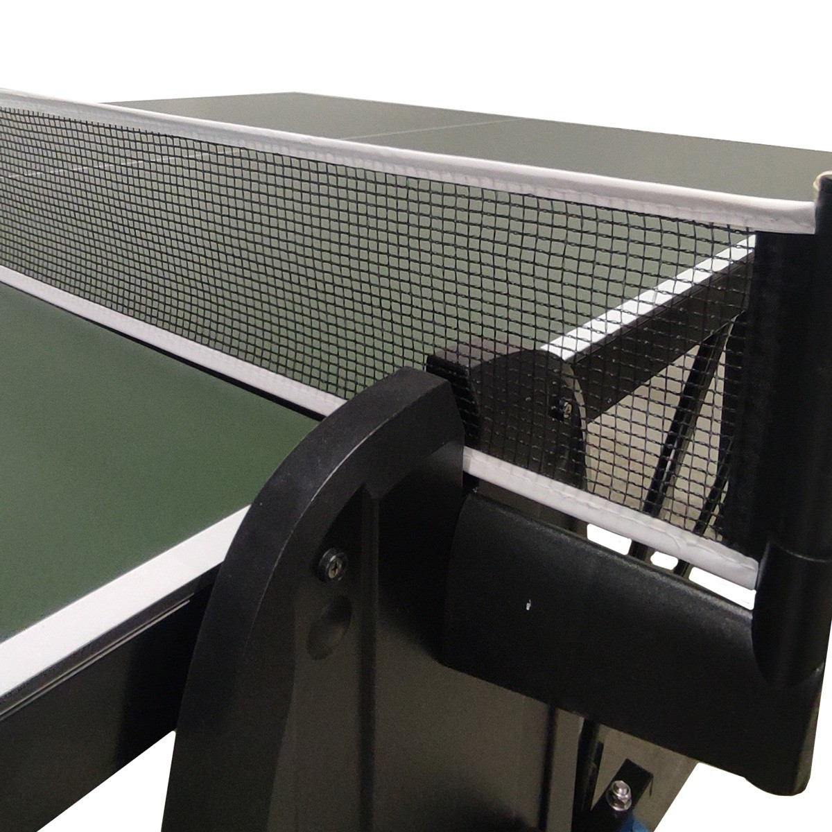 Close-up of a ping pong table. A net is stretched across the center. The table is green with white edges, black supports.