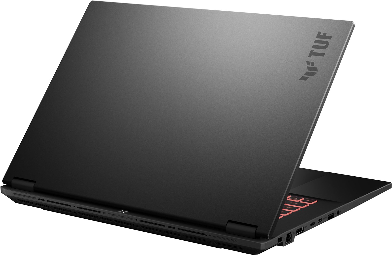 Portátil negro, parcialmente abierto. La tapa muestra el logotipo TUF. El teclado es visible, con teclas rojas.