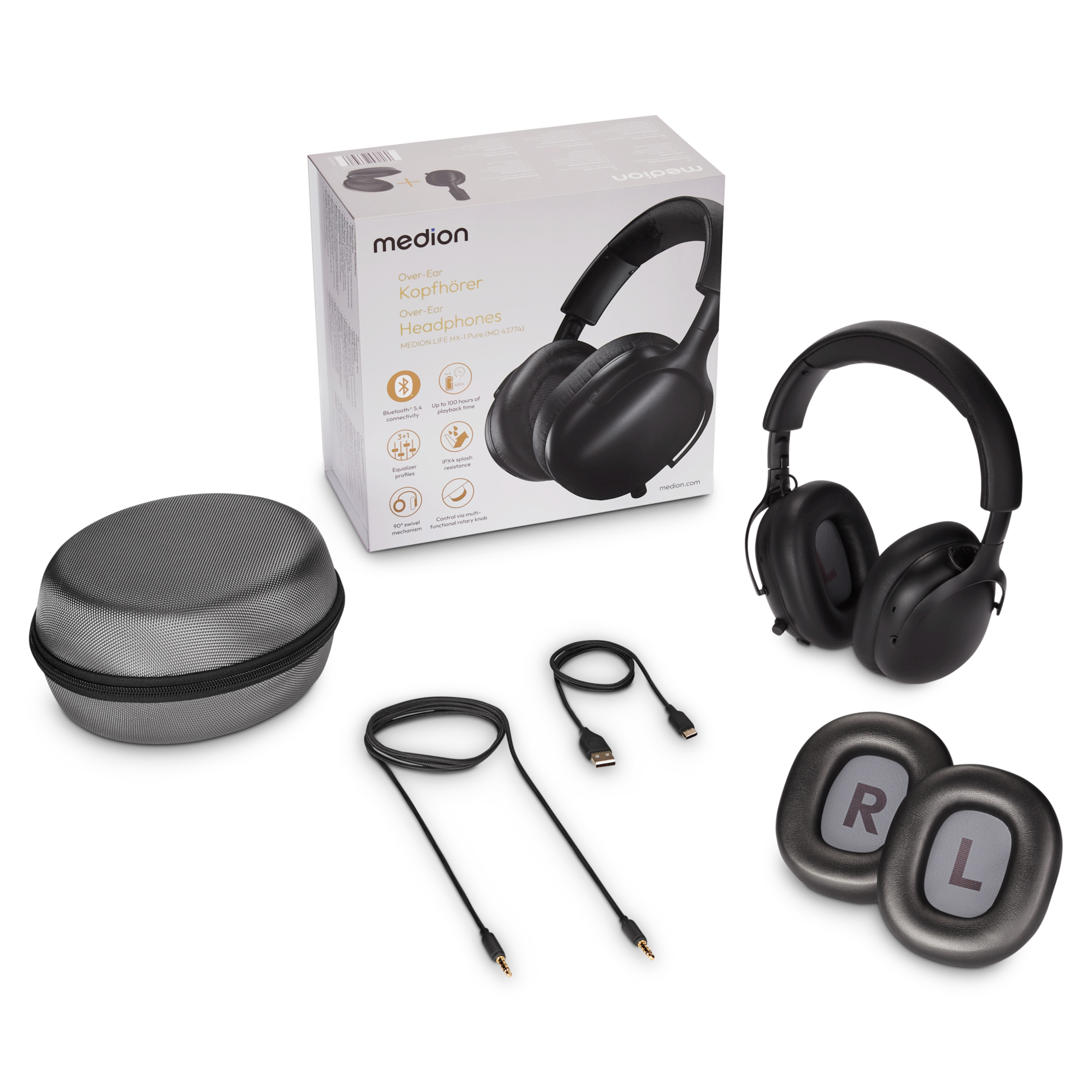 Black headphones, box, case, cables, and ear pads labeled 'R' and 'L' are on a white surface.