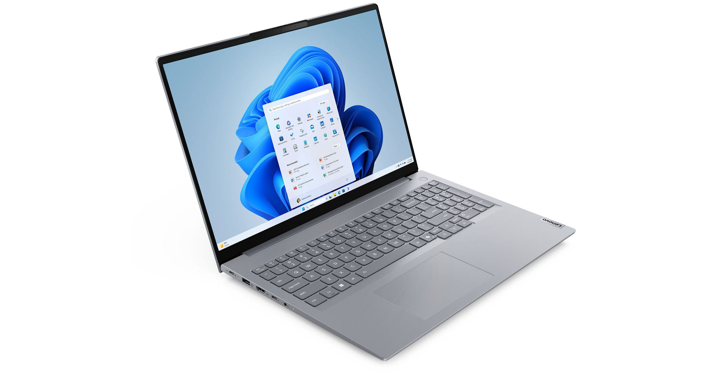 A Lenovo laptop is open, displaying the Windows 11 interface. The screen shows the start menu and a blue abstract background.
