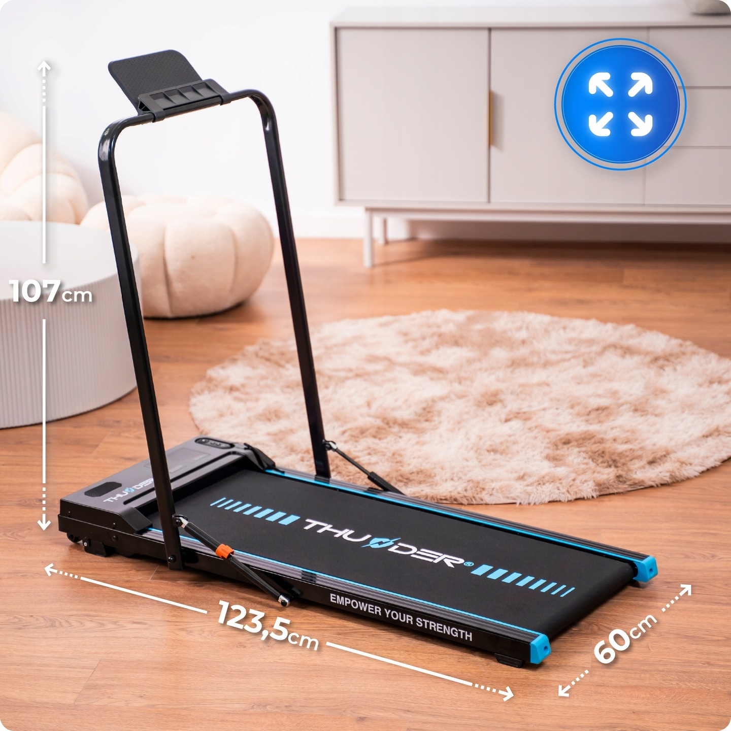 Czarno-niebieska bieżnia na drewnianej podłodze. Biała szafka i beżowy dywan w tle. Rozmiar jest wskazany.