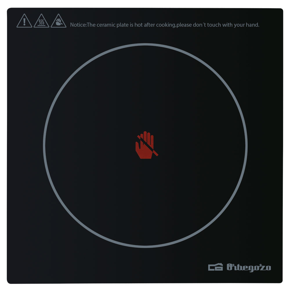 Czarna płyta ceramiczna z białym okręgiem. Symbole ostrzegawcze i tekst. Czerwona dłoń z krzyżem. Logo Orbegozo.