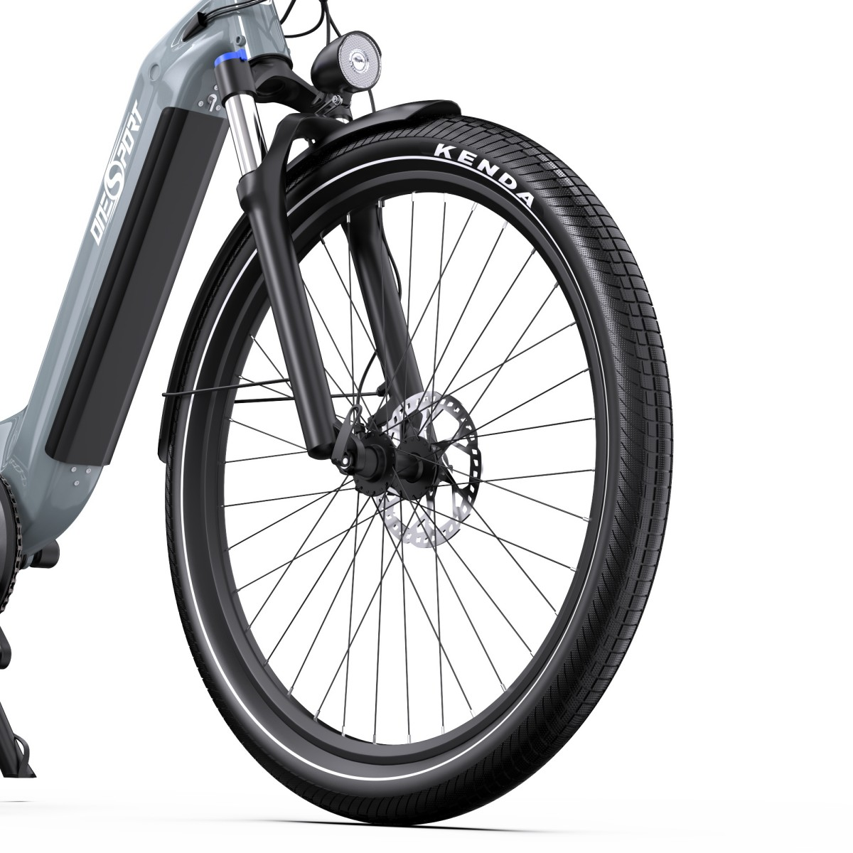 Vista ravvicinata della ruota anteriore di una bicicletta. Il pneumatico ha il marchio Kenda. La bici è grigia e nera.