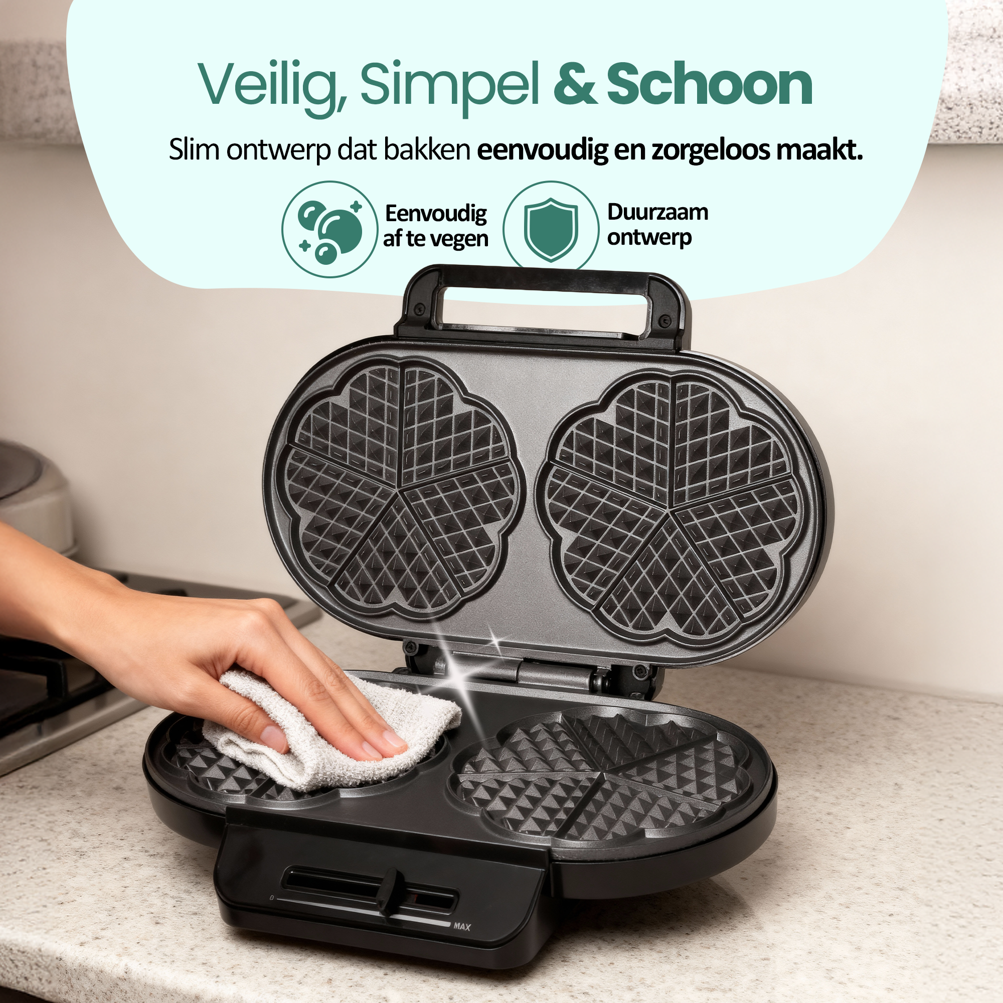 A person cleaning a waffle iron with a cloth. The iron is black with a heart-shaped pattern.