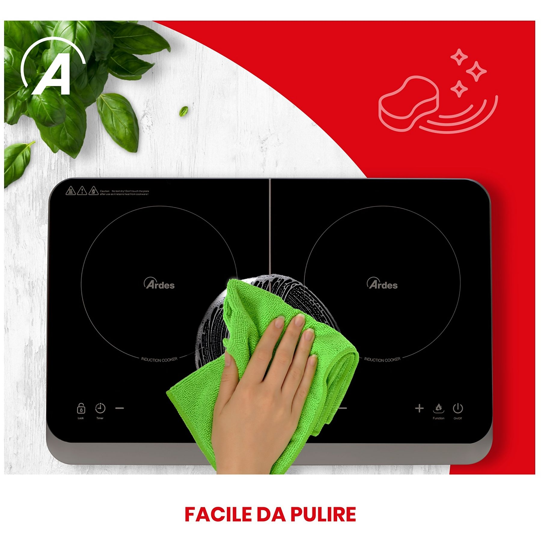 Ręka czyści czarną płytę indukcyjną zieloną szmatką. W tle widać liście bazylii.