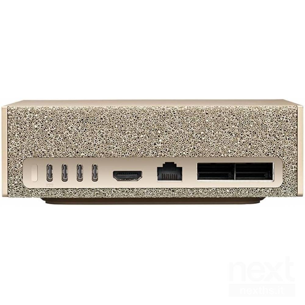 Een beige apparaat met meerdere poorten. Poorten zijn USB, HDMI en Ethernet. Het apparaat heeft een textuur.