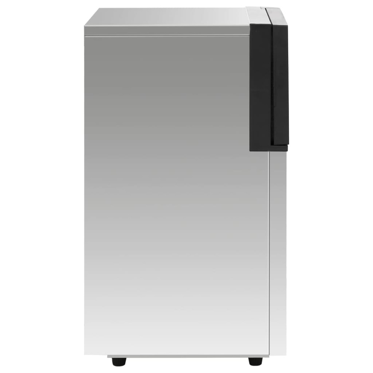 Metalowe, prostokątne urządzenie z czarnym panelem bocznym. Stoi na czterech małych, czarnych nóżkach. Powierzchnia jest odblaskowa.