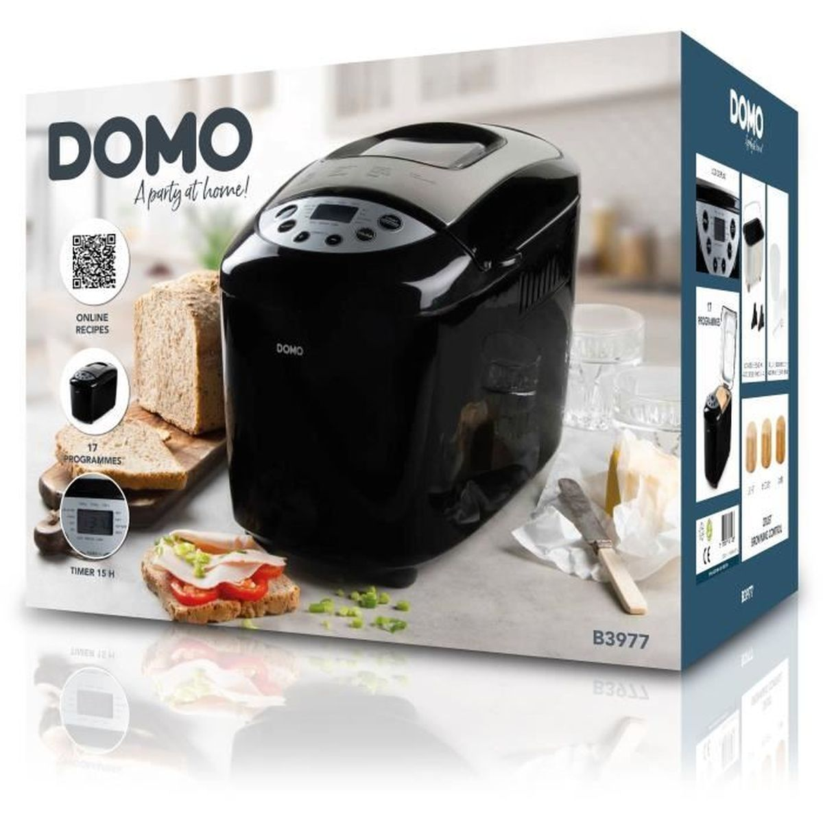 Ein DOMO-Brotbackautomat steht auf einer Schachtel mit Brot, einem Sandwich, Butter und einem Messer. Die Box enthält Informationen.