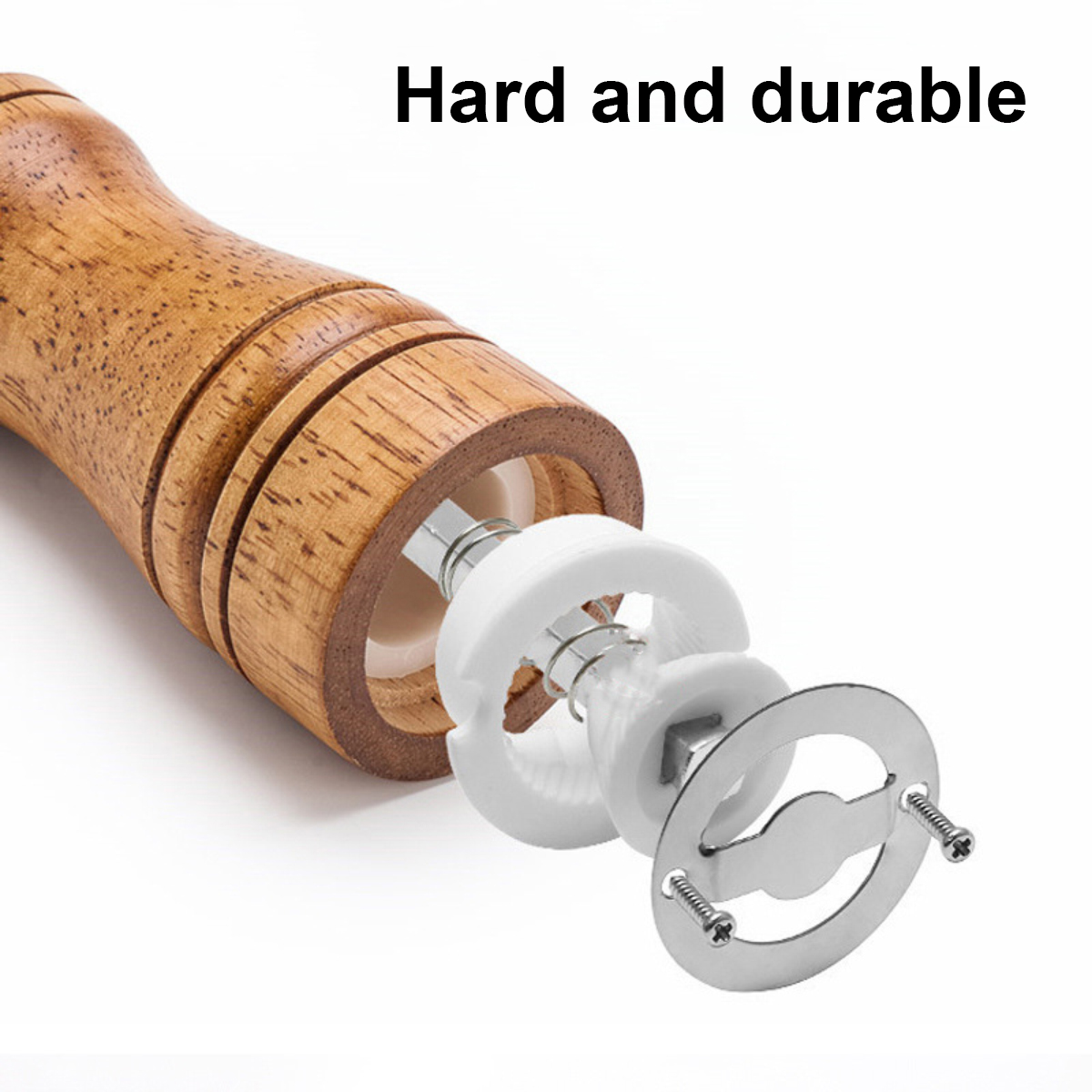 Eine zerlegte Pfeffermühle. Der Holzgriff ist links. Weiße Mahlteile und Metallkomponenten sind zu sehen.