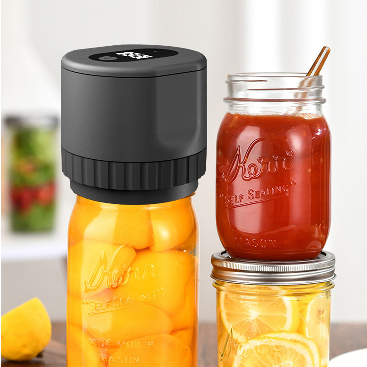 Ein Einmachglas mit Pfirsichen wird von einem schwarzen Gerät bedeckt. Zwei weitere Gläser sind sichtbar, eines mit Tomatensauce und eines mit Zitronen.
