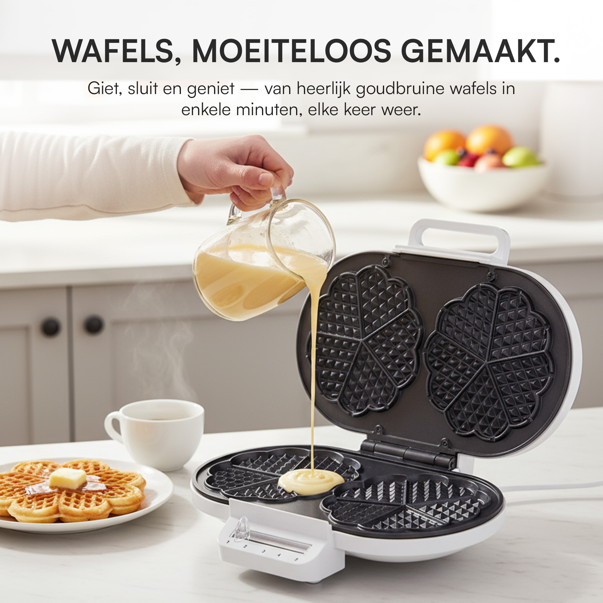 A person pouring batter into a waffle iron. Waffles are on a plate. Fruit and a cup are in the background.