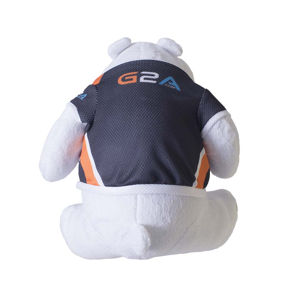 Un peluche di orso polare bianco, che indossa una maglia blu scuro con dettagli arancioni e bianchi. La maglia ha il logo 'G2A.COM' sul retro.