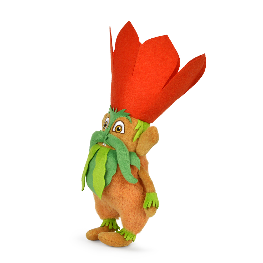 Ein Plüschtier in Form eines Wesens mit orangefarbenem Körper, grünem Bart und einem roten blütenartigen Hut. Es hat große Augen und kleine Hände.