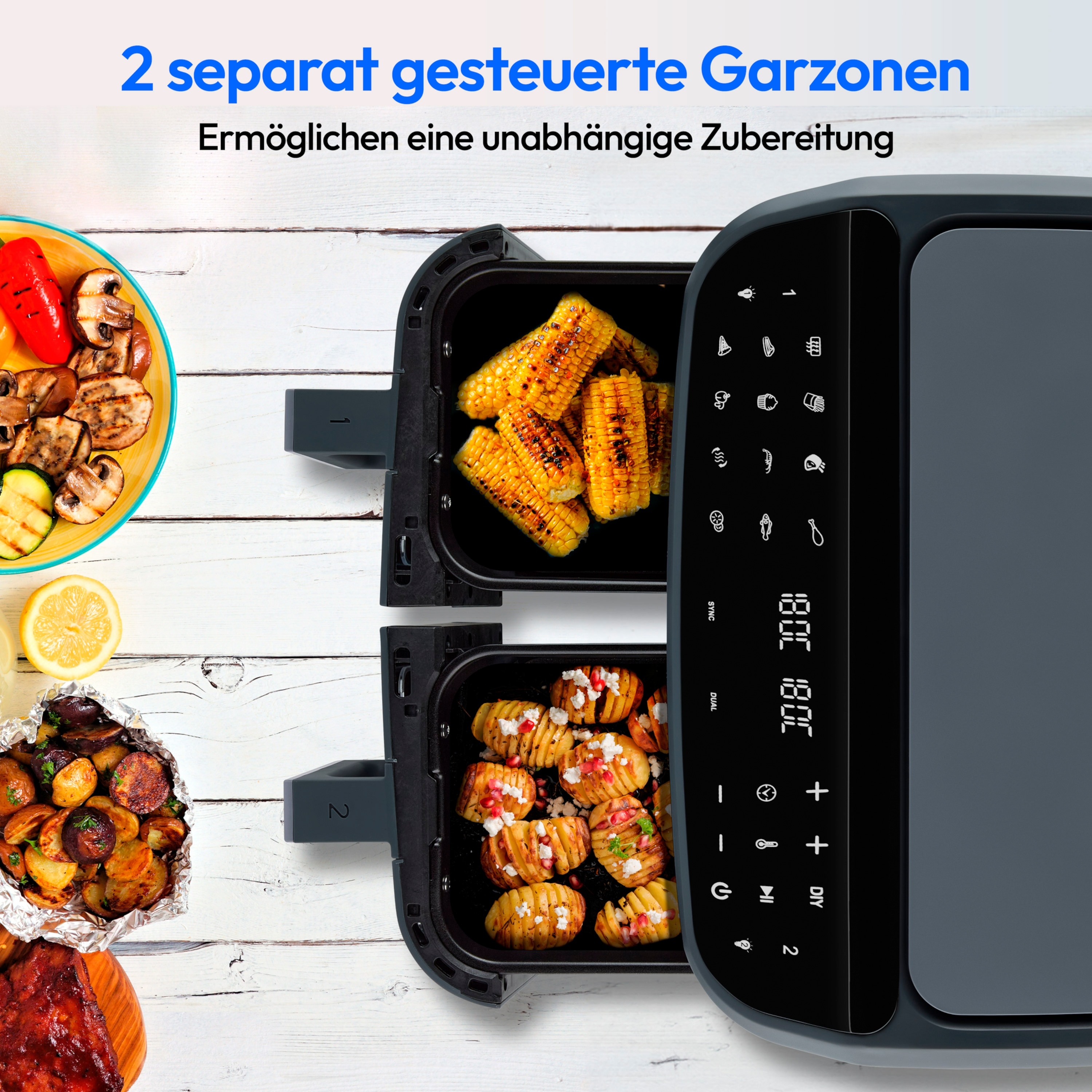 Een airfryer met twee compartimenten, één met maïs, de andere met aardappelen. Gegrild eten ernaast.