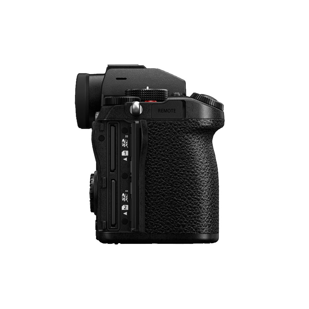A black camera body, side view. Features include a lens mount, control dials, SD card slots, and a textured grip. Isolated on white.