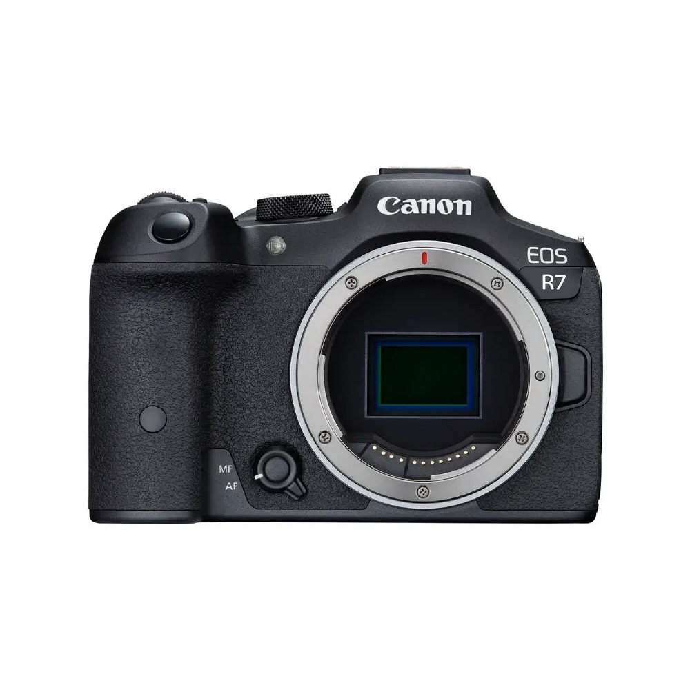 A Canon EOS R7 camera. It's black with a lens mount and the Canon logo. The lens opening reveals a green sensor.