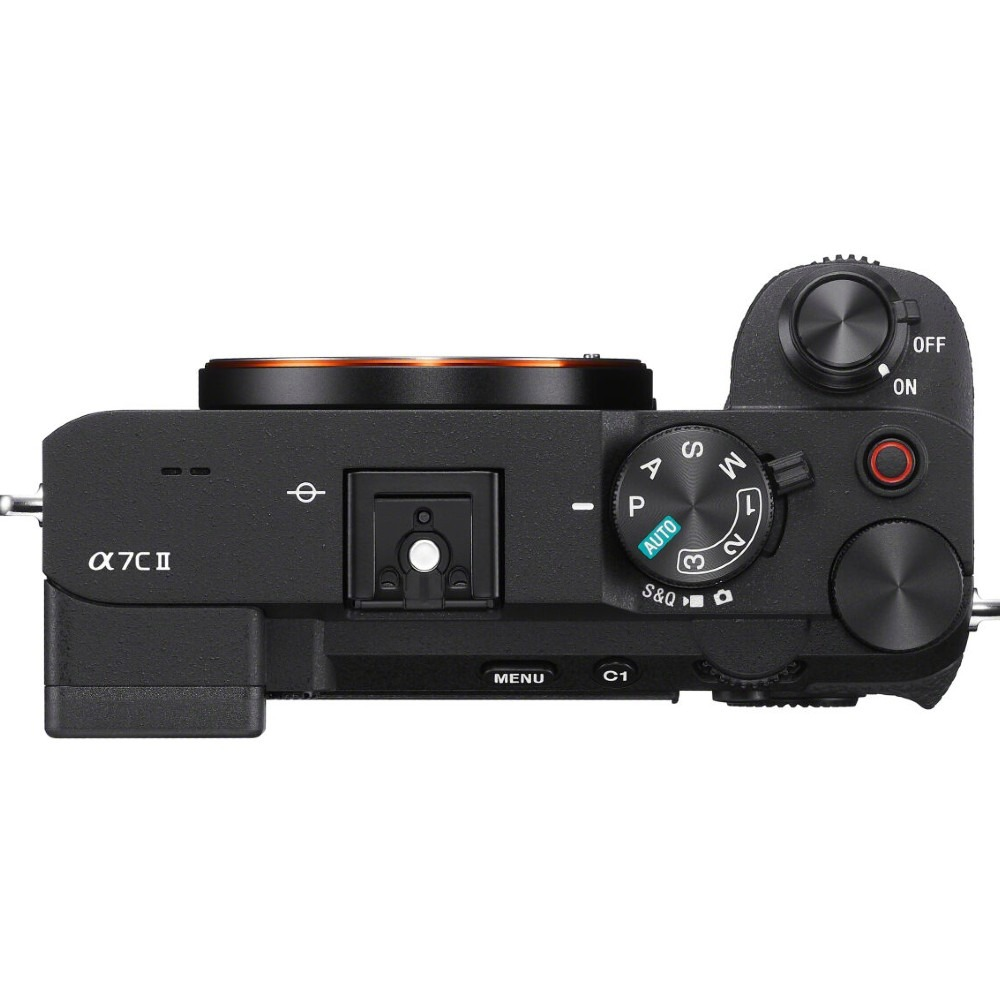A black Sony α7II camera is shown from above. It has dials, buttons, and a lens mount. The camera is on a white surface.