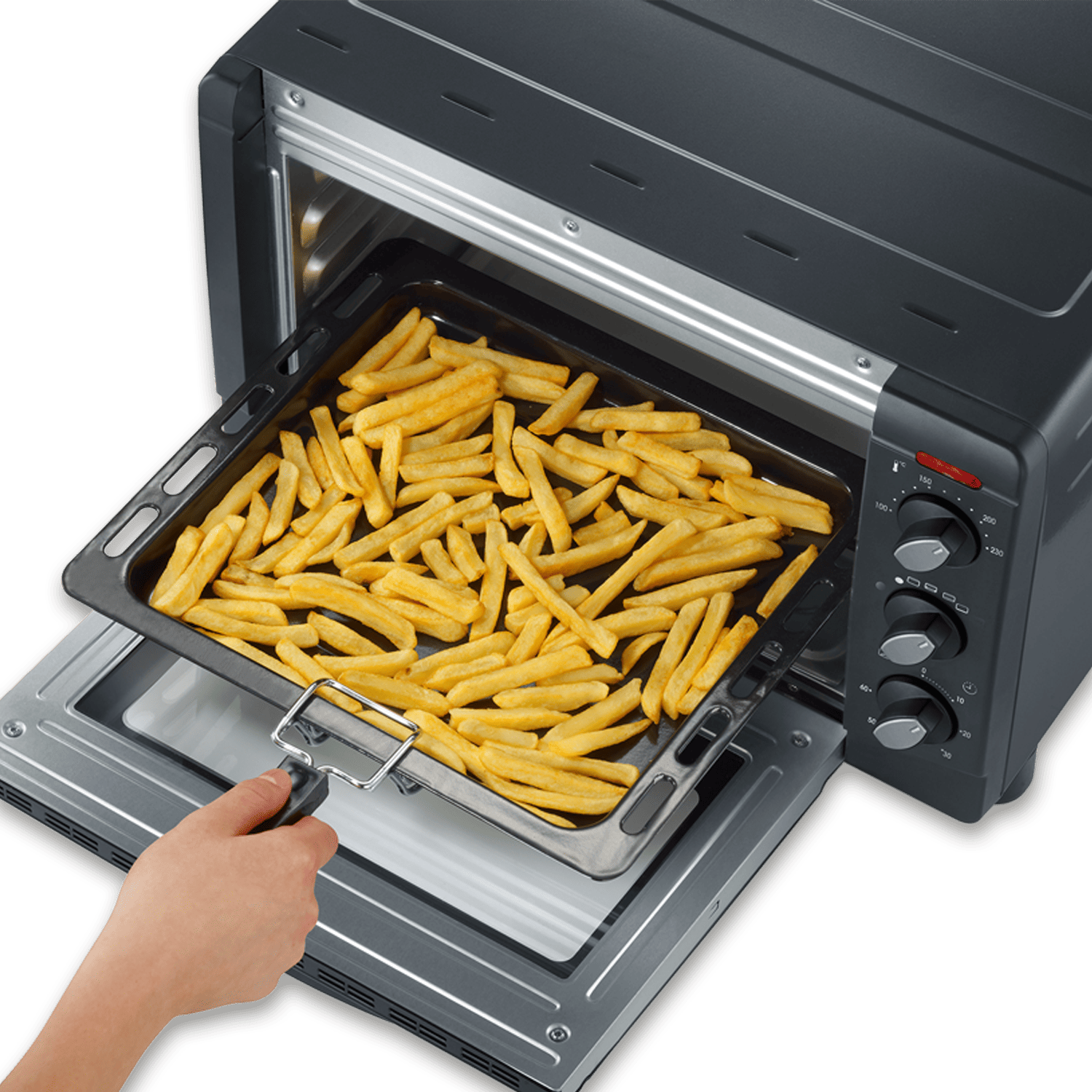 Ręka wyciąga tacę ze złotymi frytkami z czarnego piekarnika. Piekarnik stoi na zielonym tle.