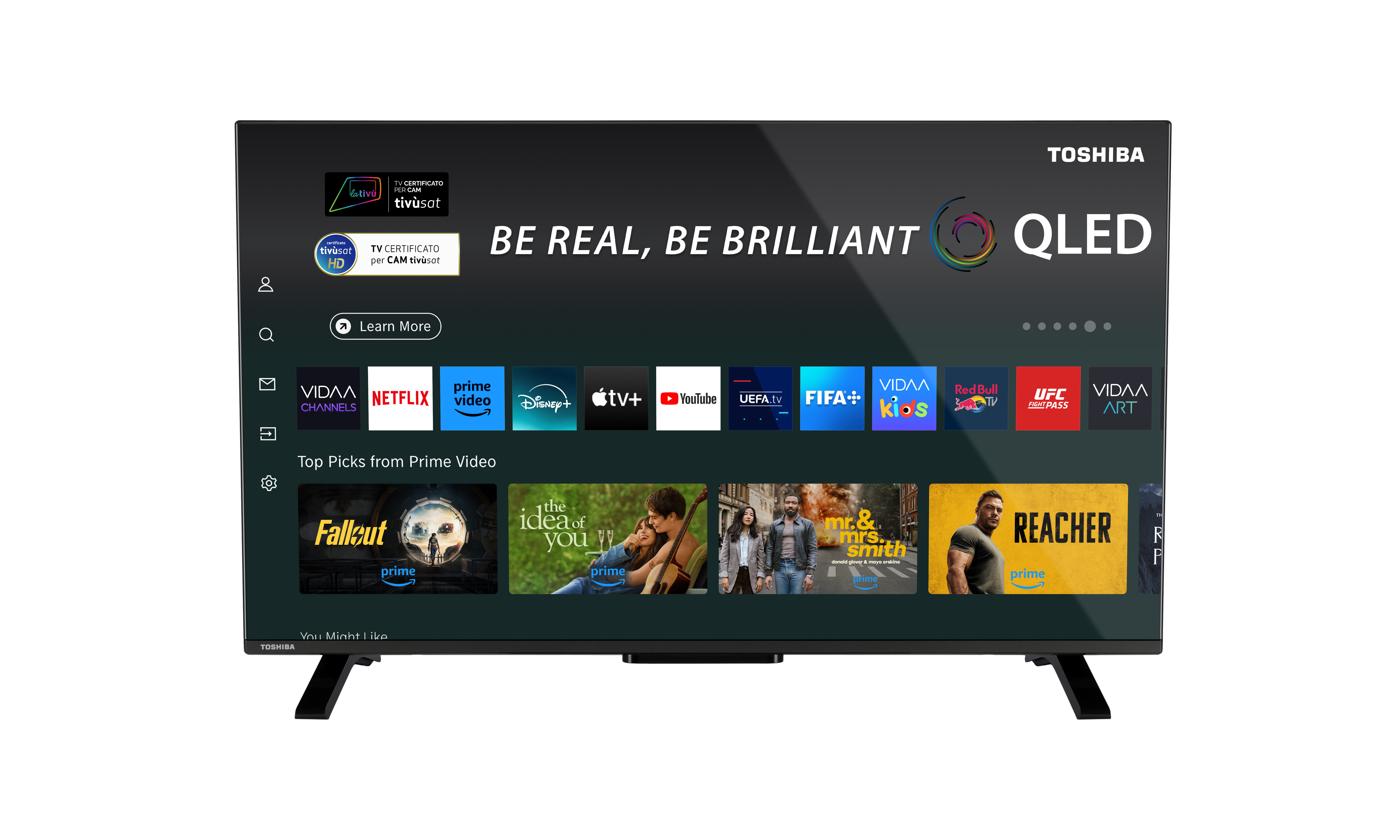 Il TV Toshiba QLED mostra app di streaming, Prime Video e loghi. Lo schermo mostra 'Be Real, Be Brilliant'.