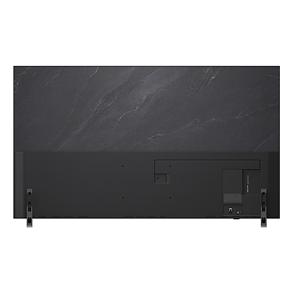 Vista posteriore di una grande TV nera con pannello posteriore grigio strutturato. Ha due supporti argentati e porte in basso.