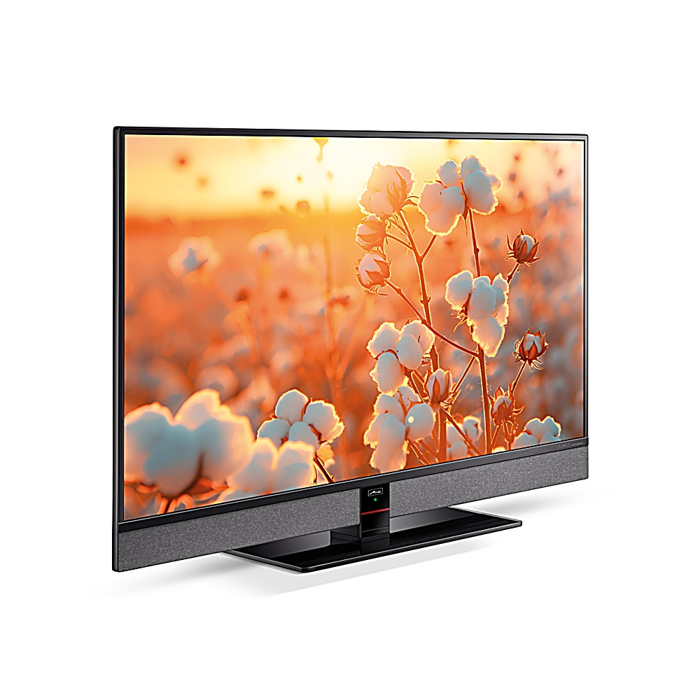 Un televisore a schermo piatto mostra un campo di cotone al tramonto. Il televisore ha una cornice nera, un altoparlante grigio e un supporto nero, su bianco.