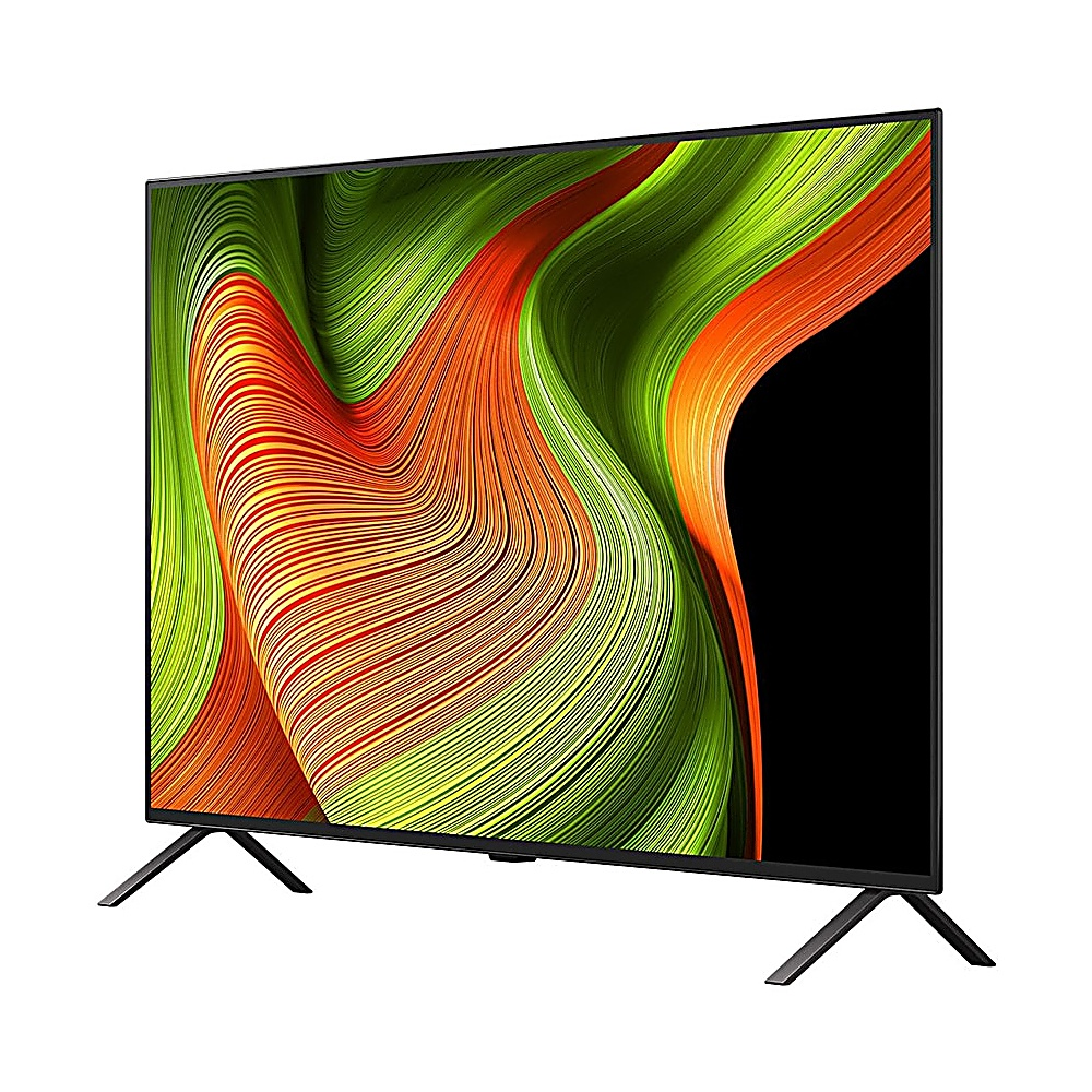 Ein Flachbildfernseher zeigt ein buntes, abstraktes Muster aus Grün, Orange und Gelb. Der Fernseher hat schwarze Beine und einen Rahmen.