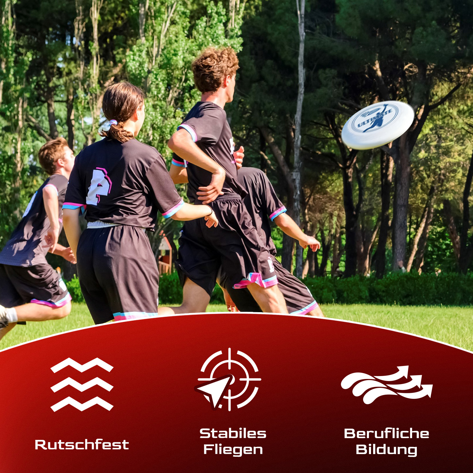 Leute spielen Frisbee. Spieler in schwarzen Uniformen rennen auf grünem Gras. Eine weiße Frisbeescheibe ist in der Luft. Bäume bilden den Hintergrund.