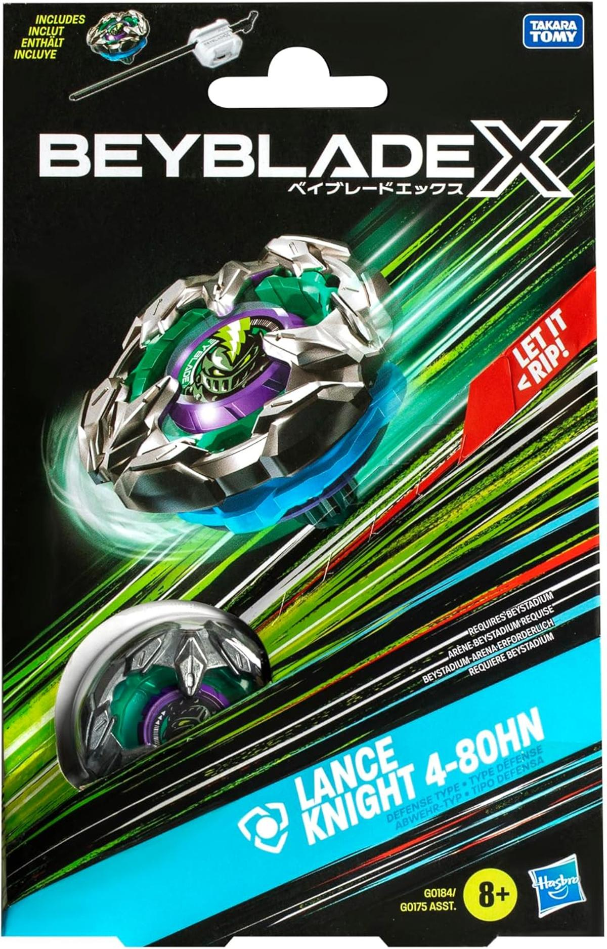 Eine Beyblade X-Box. Sie zeigt einen Kreisel, einen Werfer und Texte wie 'Beyblade X' und 'Let it rip!'. Die Farben sind Grün, Silber und Blau.