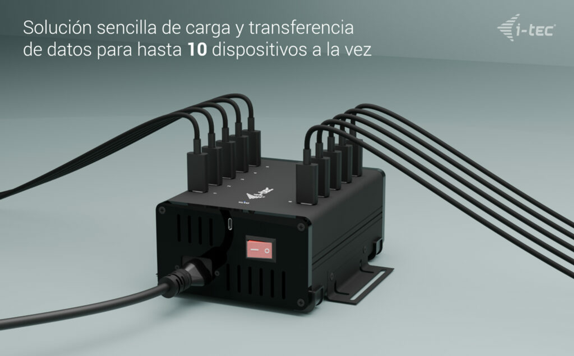 Dispositivo negro con múltiples puertos USB. Cables conectados. Interruptor rojo visible. El fondo es gris.