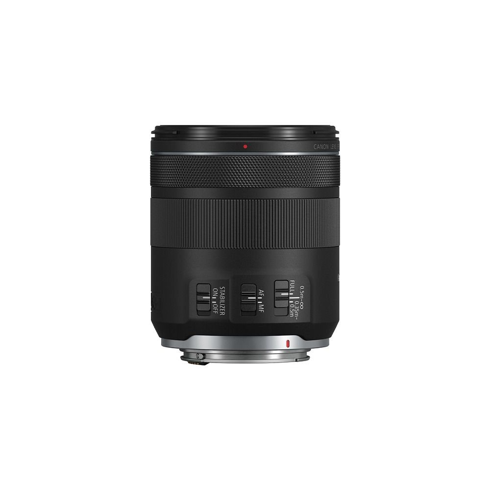 A Canon lens stands alone. It is black with silver base. Controls include stabilizer, AF/MF, and distance settings.