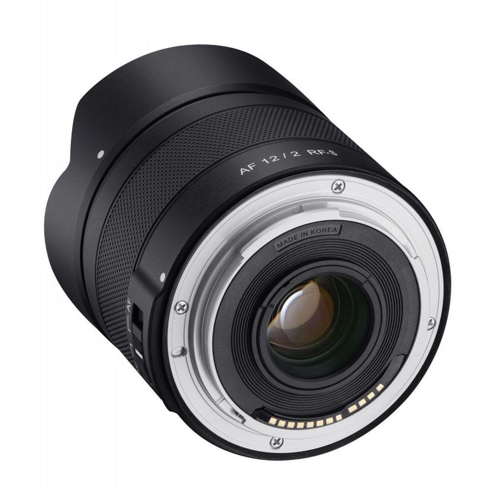 A black camera lens with silver accents. It has text that says 'AF 12/2 RF-S' and 'Made in Korea'.