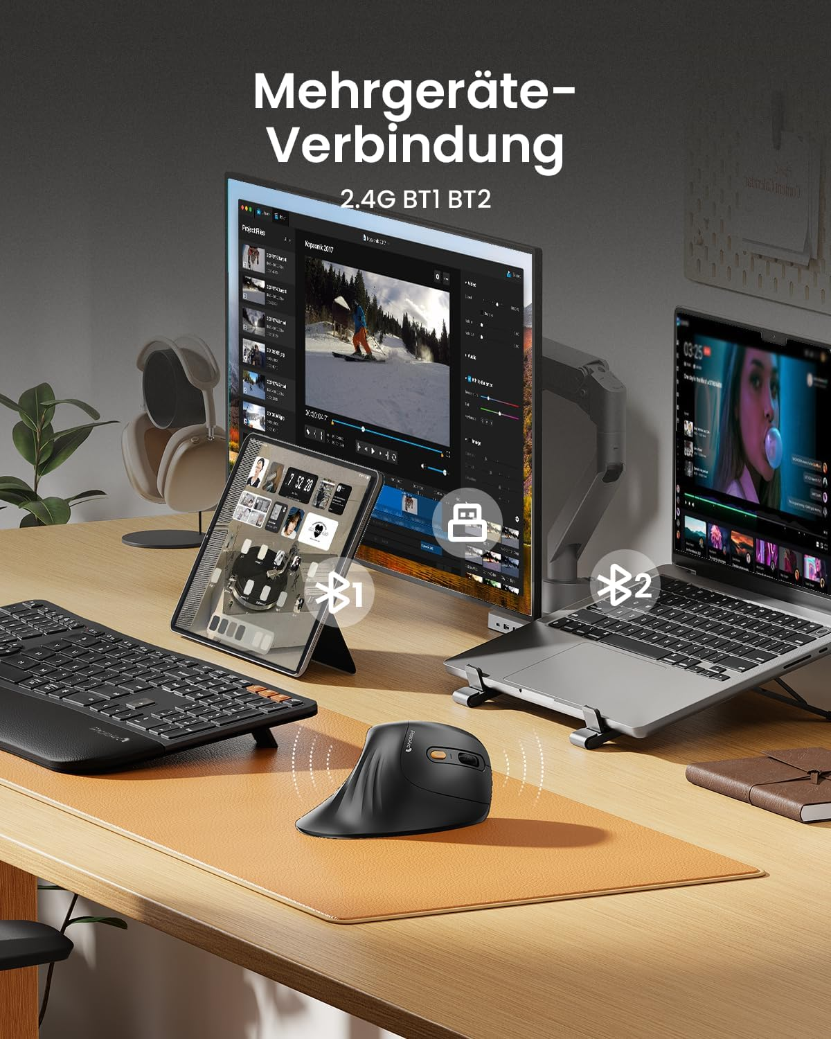 Konfiguracja biurka z monitorem, tabletem i laptopem. Obecna jest czarna mysz i klawiatura. Widoczne są symbole połączenia Bluetooth.