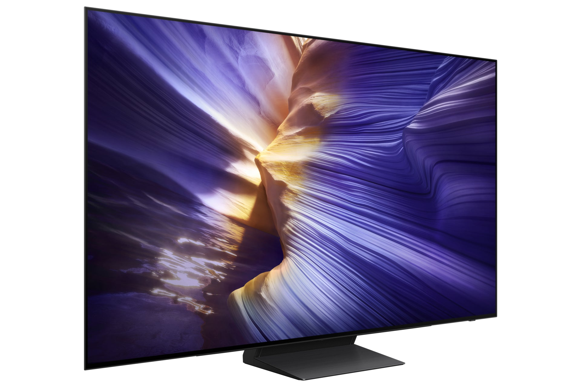 A flat-screen TV displays a wavy landscape in purple, yellow, and white. The TV is black, with a black stand, set against a white backdrop.
