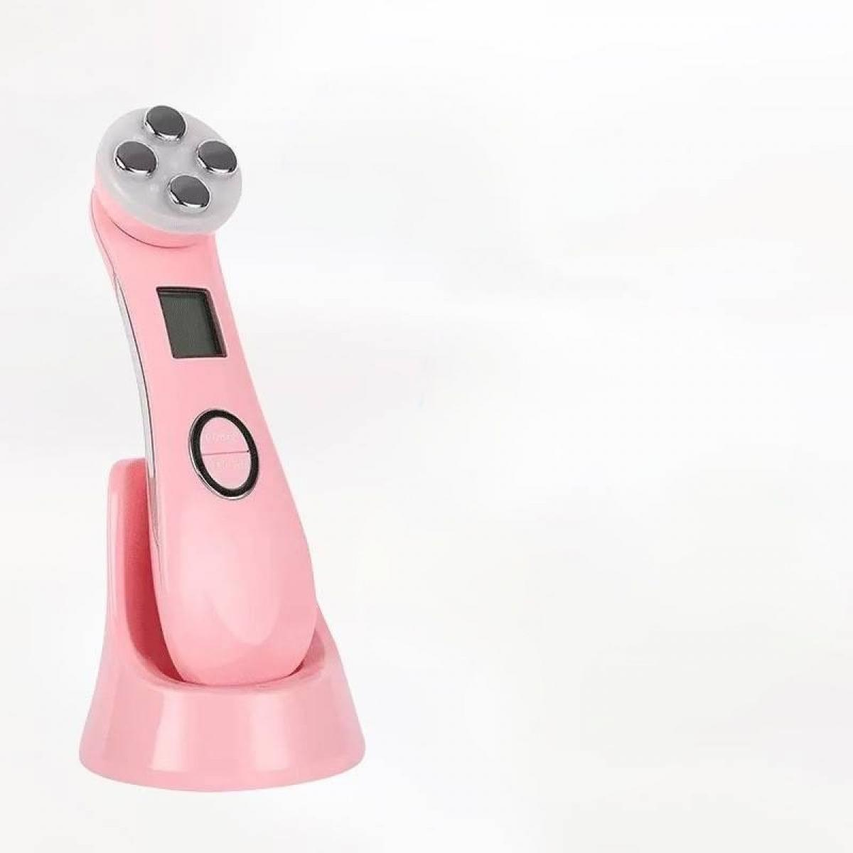 Ein pinkfarbenes Gesichtsgerät mit vier Kreisen oben, einem Bildschirm und einer Taste. Es befindet sich in seiner Ladestation, auf weißem Hintergrund.