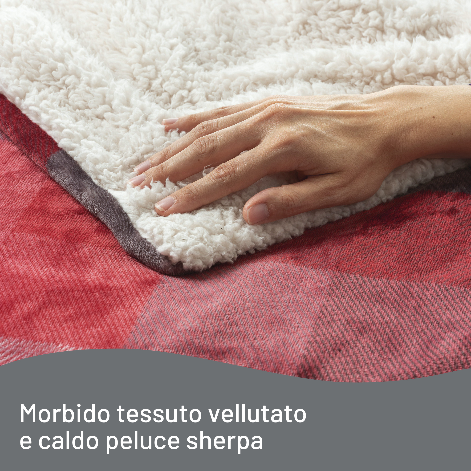 Una mano descansa sobre una suave manta sherpa blanca sobre una manta a cuadros roja. La escena muestra una textura acogedora.