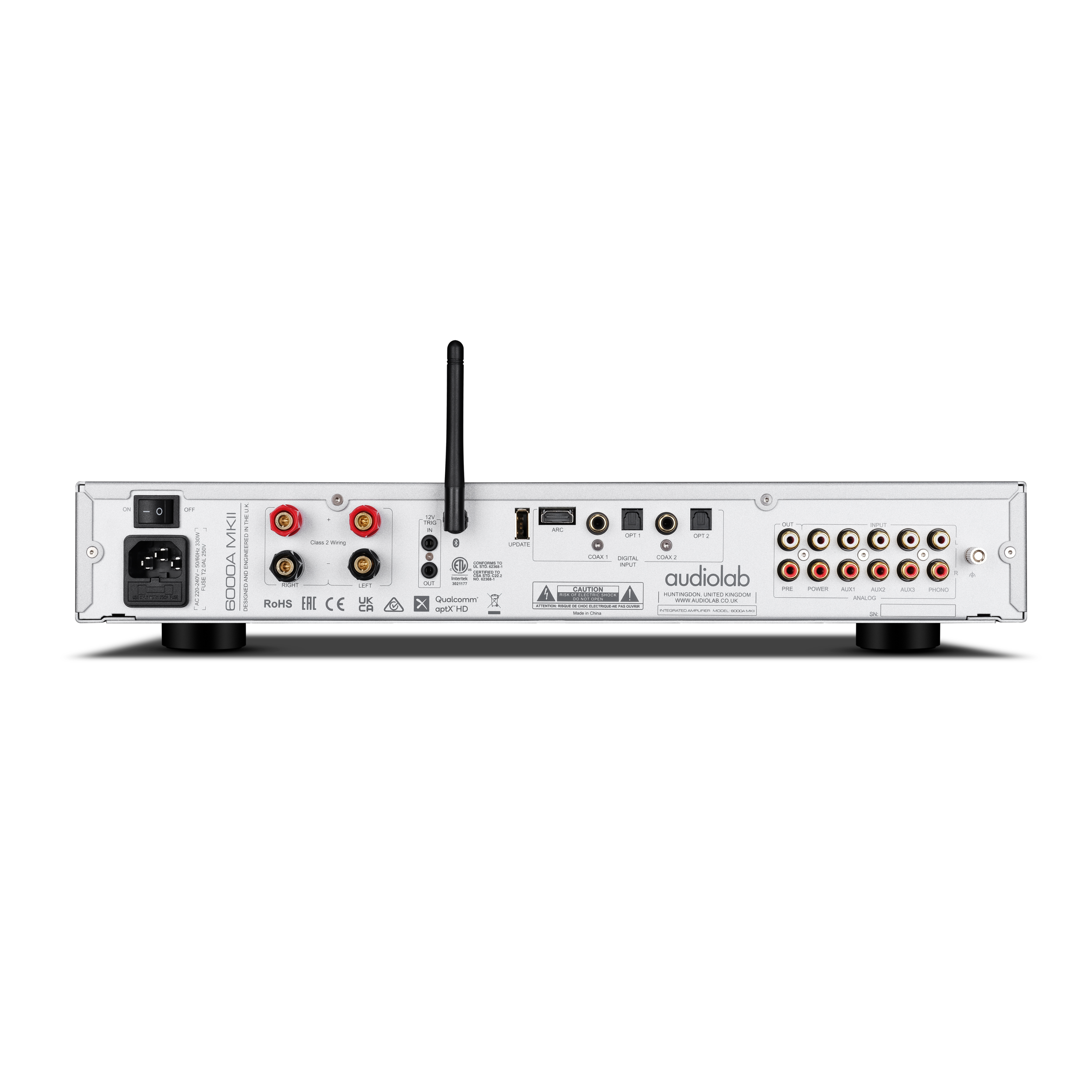 Rear view of an audio amplifier. It has various input/output ports, a power switch, and a black antenna.