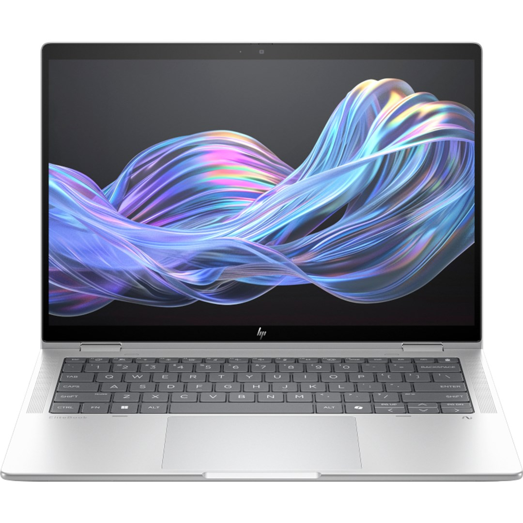 Una computadora portátil plateada está abierta. La pantalla muestra un diseño abstracto y colorido. El teclado es visible, con teclas etiquetadas.