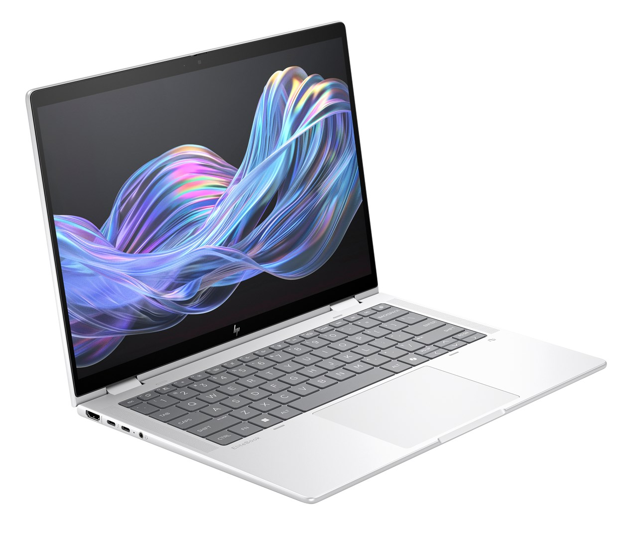 Un portátil plateado con una pantalla que muestra formas abstractas coloridas. El teclado es gris y el portátil está abierto en ángulo.
